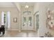 Elegant foyer with tile flooring, high ceilings, decorative lighting, and a view into the living spaces at 14715 Fishhawk Preserve Dr, Lithia, FL 33547