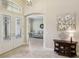 Elegant foyer featuring tile floors, a decorative console table, and a view into the living room at 14715 Fishhawk Preserve Dr, Lithia, FL 33547
