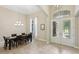 Light-filled foyer with elegant tile floors, dining area and decorative glass double-door entry at 14715 Fishhawk Preserve Dr, Lithia, FL 33547