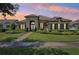 Inviting single-story home with a manicured lawn, stone accents, and a tile roof at sunset at 14715 Fishhawk Preserve Dr, Lithia, FL 33547
