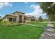 Well-manicured lawn and landscaping highlight this home’s stone facade and tile roof at 14715 Fishhawk Preserve Dr, Lithia, FL 33547