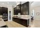 Spacious kitchen with dark cabinets, stainless steel appliances, and a view to the dining room at 14715 Fishhawk Preserve Dr, Lithia, FL 33547