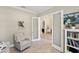 Bright living room with chair and French doors to the rest of the home at 14715 Fishhawk Preserve Dr, Lithia, FL 33547