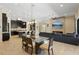 Open-concept living room and kitchen featuring a stone fireplace and an island with seating at 14715 Fishhawk Preserve Dr, Lithia, FL 33547