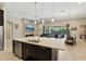 Living room featuring fireplace, kitchen with island, dining table, and sliding glass doors at 14715 Fishhawk Preserve Dr, Lithia, FL 33547