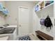Functional mud room featuring washer and dryer, built-in storage and bench with hooks at 14715 Fishhawk Preserve Dr, Lithia, FL 33547