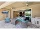 Cozy outdoor living area featuring plush seating, a fire pit, and an outdoor kitchen at 14715 Fishhawk Preserve Dr, Lithia, FL 33547
