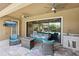 Outdoor living space with comfortable seating, a fireplace, and an outdoor kitchen for entertaining at 14715 Fishhawk Preserve Dr, Lithia, FL 33547