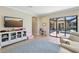Large playroom with a TV, cabinets, seating, and access to the outside patio and pool area at 14715 Fishhawk Preserve Dr, Lithia, FL 33547