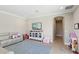 Spacious playroom with a white cabinet, TV, blue rug, and a cozy sofa at 14715 Fishhawk Preserve Dr, Lithia, FL 33547