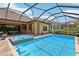 Captivating screened-in pool and spa with a covered outdoor kitchen and dining area at 14715 Fishhawk Preserve Dr, Lithia, FL 33547