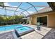 Luxurious screened-in pool and spa with a beautifully landscaped patio and outdoor seating at 14715 Fishhawk Preserve Dr, Lithia, FL 33547