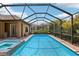Inviting screened-in pool with a spa and lush green landscaping for privacy at 14715 Fishhawk Preserve Dr, Lithia, FL 33547