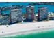 Stunning aerial view of beachfront condos, showcasing pristine white sands and turquoise waters at 17920 Gulf Blvd # 1806, Redington Shores, FL 33708