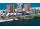 Aerial shot showcasing tall condos near the water, a parking garage, and lush, green landscaping at 17920 Gulf Blvd # 1806, Redington Shores, FL 33708