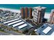 Aerial view displaying beachfront condos, Gulf of Mexico, and a well-organized parking area for residents at 17920 Gulf Blvd # 1806, Redington Shores, FL 33708