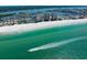 Stunning aerial view of a white sand beach, turquoise water, and tall condos along the shore at 17920 Gulf Blvd # 1806, Redington Shores, FL 33708