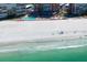 Aerial view of a building alongside a white sand beach with blue ocean waves crashing on the shore at 17920 Gulf Blvd # 1806, Redington Shores, FL 33708