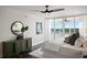 Bright bedroom with modern decor, balcony access, and views of the water at 17920 Gulf Blvd # 1806, Redington Shores, FL 33708