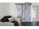 Bright hallway with modern sliding barn door, leading to various rooms and closet space at 17920 Gulf Blvd # 1806, Redington Shores, FL 33708