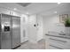 Bright kitchen featuring stainless steel refrigerator, white cabinets, and granite countertops for a modern look at 17920 Gulf Blvd # 1806, Redington Shores, FL 33708