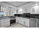 Renovated kitchen with granite counters, modern stainless appliances and new white cabinets at 17920 Gulf Blvd # 1806, Redington Shores, FL 33708