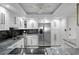 Kitchen features stainless appliances, granite counters and white cabinetry at 17920 Gulf Blvd # 1806, Redington Shores, FL 33708