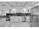 Updated kitchen featuring stainless steel appliances, granite counters and white cabinetry at 17920 Gulf Blvd # 1806, Redington Shores, FL 33708