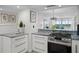 A modern kitchen featuring white cabinets and stylish countertops at 17920 Gulf Blvd # 1806, Redington Shores, FL 33708