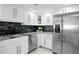Renovated kitchen features stainless appliances, granite counters and white shaker cabinets at 17920 Gulf Blvd # 1806, Redington Shores, FL 33708