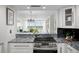 Bright kitchen features granite counters, stainless steel appliances, and a pass-through to the living area at 17920 Gulf Blvd # 1806, Redington Shores, FL 33708