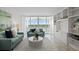 Sunlit living room with built-in shelving, comfy sofas, and sliding glass doors leading to a balcony at 17920 Gulf Blvd # 1806, Redington Shores, FL 33708