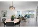 Inviting living area featuring stylish furnishings, a unique chandelier, and scenic views from large windows at 17920 Gulf Blvd # 1806, Redington Shores, FL 33708