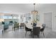 Bright living room features built-in shelves, a dining area, and a serene view from large glass doors at 17920 Gulf Blvd # 1806, Redington Shores, FL 33708