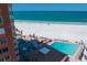 Aerial view of a community pool, white sand beach and the ocean on a sunny day at 17920 Gulf Blvd # 1806, Redington Shores, FL 33708