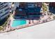 Inviting community pool surrounded by lounge chairs, located next to the beach and buildings at 17920 Gulf Blvd # 1806, Redington Shores, FL 33708