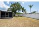 A large backyard is fully fenced for privacy at 1818 Willow Oak Dr, Palm Harbor, FL 34683