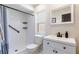 Bathroom featuring a shower, sink, toilet, and window at 1818 Willow Oak Dr, Palm Harbor, FL 34683