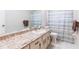 Cozy bathroom featuring countertop, a mirror, and neutral color scheme at 1818 Willow Oak Dr, Palm Harbor, FL 34683