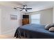 Comfortable bedroom with a blue bedspread, carpeted floor, dresser with TV, and natural light at 1818 Willow Oak Dr, Palm Harbor, FL 34683