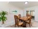 Inviting dining area with wood table and chairs, natural light, and sliding glass doors leading to the outside at 1818 Willow Oak Dr, Palm Harbor, FL 34683