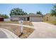 Charming single-story home featuring a well-maintained lawn, concrete driveway, and a classic mailbox at 1818 Willow Oak Dr, Palm Harbor, FL 34683
