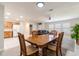 View of the living space showing the dining area, living room with leather sofa, and adjacent kitchen at 1818 Willow Oak Dr, Palm Harbor, FL 34683