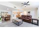 Bright open-concept living space with dining area and a glimpse of the kitchen featuring modern appliances and tile flooring at 1818 Willow Oak Dr, Palm Harbor, FL 34683