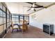 The sunroom offers a fan and table at 1818 Willow Oak Dr, Palm Harbor, FL 34683