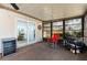 This sunroom has a slider door, wine cooler, and blackstone grill at 1818 Willow Oak Dr, Palm Harbor, FL 34683