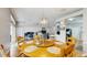 Inviting dining area with wood table, seating for six, and view into the living room and kitchen at 19635 Bellehurst Loop, Land O Lakes, FL 34638