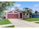 Lovely one-story home with manicured lawn, mature landscaping, and a two-car garage at 19635 Bellehurst Loop, Land O Lakes, FL 34638