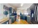 Well-equipped kitchen with dark cabinets, stainless steel appliances, and a view into the dining room at 19635 Bellehurst Loop, Land O Lakes, FL 34638