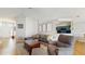 Open-concept living room showcasing hardwood floors, modern furnishings, and view into the kitchen at 19635 Bellehurst Loop, Land O Lakes, FL 34638